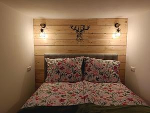 a bedroom with a bed with a wooden headboard at Berghof Reiter in Weissbriach
