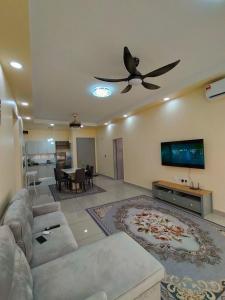 a living room with a couch and a ceiling fan at Yaya Suites Homestay Palmyra Residence Bangi in Kampong Batu Lima Bangi