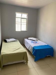 Posteľ alebo postele v izbe v ubytovaní Casa em São Tomé/Base Naval