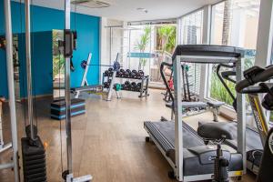 a gym with several tread machines in a room at Nadai Confort Hotel e Spa in Foz do Iguaçu