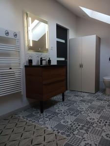 a bathroom with a sink and a mirror and a toilet at le calme atlantique in Pornic +6 photos