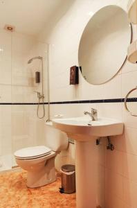 a bathroom with a toilet and a sink and a mirror at Pita 3, San Jose, Nijar in San José