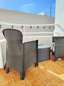 two wicker chairs sitting under a table in a room at Pita 3, San Jose, Nijar in San José