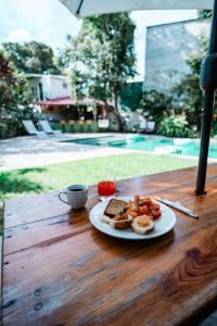 a plate of food on a table with a cup of coffee at Casa Amaranto in Panajachel