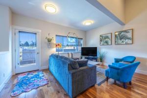 a living room with a blue couch and a tv at Hull Street Loft in Hood River
