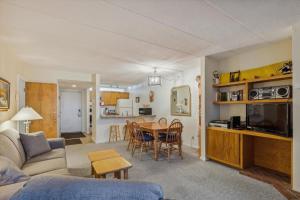 a living room with a couch and a table at Pinnacle E11 in Killington
