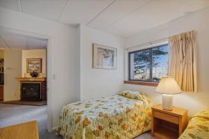 a bedroom with a bed and a window at Pinnacle E11 in Killington +13 photos