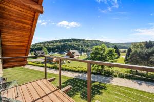 a balcony with a view of the mountains at Walk to Village! Stunning timber chalet! Hot-Tub, Bonfire & more! in Ellicottville