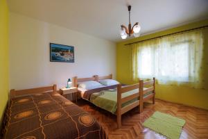 Postel nebo postele na pokoji v ubytování Apartmany Kosić