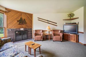 a living room with a couch and a tv at Trail Creek 11 in Killington