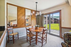 a dining room with a wooden table and chairs at Trail Creek 11 in Killington