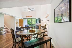 a dining room and living room with a table and chairs at Pinnacle D17 in Killington