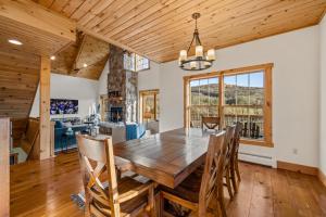 een eetkamer met een houten tafel en stoelen bij New & Stunning Chalet! Reno'd, Hot-Tub, Barrel Sauna, Slope Views, Fire Pit in Ellicottville