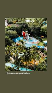 an aerial view of a water park with palm trees at Hotel Tierra Santa in Santa Fe de Antioquia