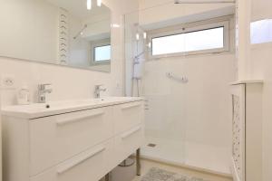 a white bathroom with a sink and a shower at BRIDGESTREET MONACO - cap d ail - roquebrune in Saint-Antoine +16 photos