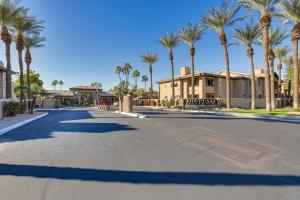a street with palm trees in front of a house at Scottsdale Condo with Fireplace and Community Pools! in Scottsdale