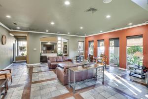 a living room with a couch and a table at Scottsdale Condo with Fireplace and Community Pools! in Scottsdale