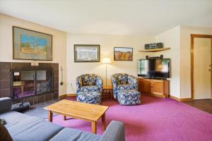 a living room with a couch and chairs and a tv at Trail Creek 57 in Killington