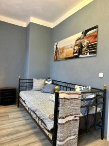 a bedroom with a bed and a picture of a car on the wall at Alter Bahnhof, mit Sauna und Whirlpool in Dahlem