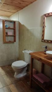 a bathroom with a toilet and a sink at Los Acacios in El Hoyo