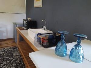 two blue vases sitting on top of a table at depto muy cómodo en 1er piso in La Plata