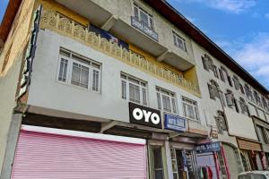 a building with a ovy sign on the side of it at Hotel Saima in Srinagar