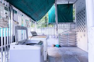 a room with a washing machine in a building at Freesia Saladaeng Silom Apartments in Bangkok