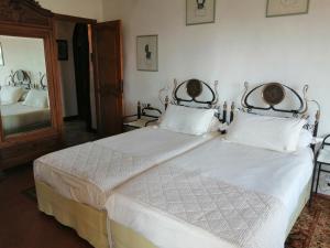 a bedroom with a bed with white sheets and a mirror at Chambres d'hôtes Les Terrasses du Soleil in Cagnes-sur-Mer +34 photos