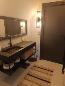 ein Bad mit einem Waschbecken und einem Spiegel in der Unterkunft Ame O des Flandres La Villa in Boeschèpe