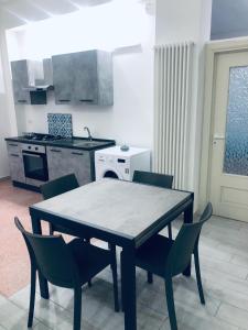 a kitchen with a table and chairs in a room at Dimora Nonna Rosa in Aversa