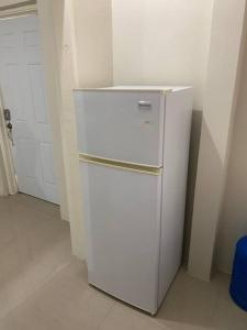 a white refrigerator in the corner of a room at Beach Walk Studio near Mobay Hip Strip in Montego Bay