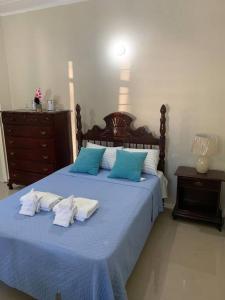 a bedroom with a blue bed with towels on it at Beach Walk Studio near Mobay Hip Strip in Montego Bay