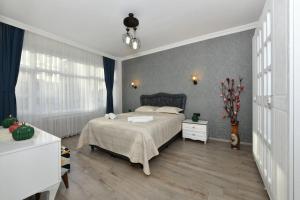 a bedroom with a large bed and a table at Center Suite 8 in Istanbul