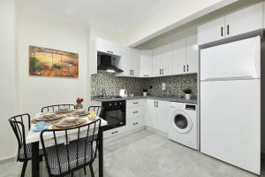 a kitchen with a table and a white refrigerator at Center Suite 8 in Istanbul