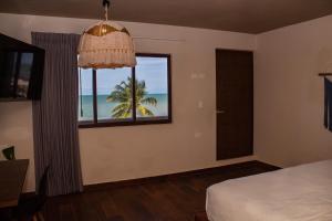 a bedroom with a window with a view of the beach at Hotel Scappata in Progreso