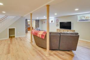 a living room with a couch and a flat screen tv at Family-Friendly Blacksburg Retreat with Playground! in Blacksburg