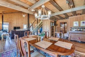 a dining room with a wooden table and chairs at Pet-Friendly Opp Vacation Rental with Spacious Deck! in Opp