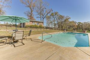 a pool with a table and chairs and an umbrella at Pet-Friendly Opp Vacation Rental with Spacious Deck! in Opp