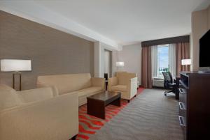 a living room with a couch and a television at Holiday Inn Express Hotel & Suites Barrie, an IHG Hotel in Barrie