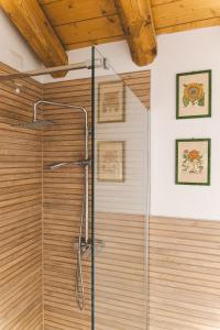 a shower in a bathroom with a wooden ceiling at la restera del sile in Casale sul Sile