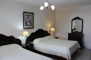 Cama ou camas em um quarto em Hotel Parador