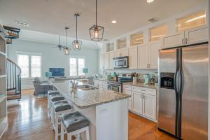 a kitchen with white cabinets and stainless steel appliances at Habersham Retreat on Abbey Row in Beaufort