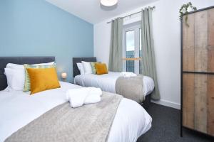 a bedroom with two beds and a window at Lyndale Lofts - By Sigma Stays in Crewe