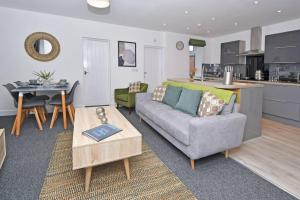 a living room with a couch and a table at Lyndale Lofts - By Sigma Stays in Crewe
