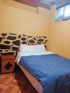 a bedroom with a bed with a cow print on the wall at Sacred Point in Ollantaytambo