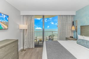 a bedroom with a bed and a view of the ocean at Stunning Oceanfront 2 Bedroom Suite- Sailfish Resort 1111 in Myrtle Beach