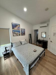 a bedroom with a bed and a desk in it at Room with private bath Santoniri inspired in Seattle