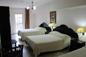 Cama ou camas em um quarto em Hotel Parador