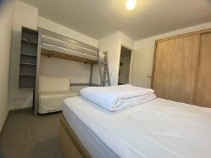 a bedroom with a bed and a bunk bed at Appartement lumineux avec terrasse & Wifi à Verchaix - FR-1-642-82 in Verchaix