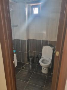 a small bathroom with a toilet in a stall at Grand Life Hotel in Çorlu